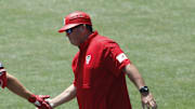 Jun 19, 2021; Omaha, Nebraska, USA;  NC State Wolfpack left fielder Jonny Butler (14) is congratulated by head coach Elliott Avent after hitting a home run against the Stanford Cardinal at TD Ameritrade Park. Mandatory Credit: Bruce Thorson-Imagn Images
