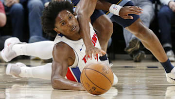 Nov 3, 2025; Memphis, Tennessee, USA; Detroit Pistons guard Ausar Thompson (9) and Memphis Grizzlies forward Jaylen Wells (0) dive for a loose ball during the first quarter at FedExForum.
