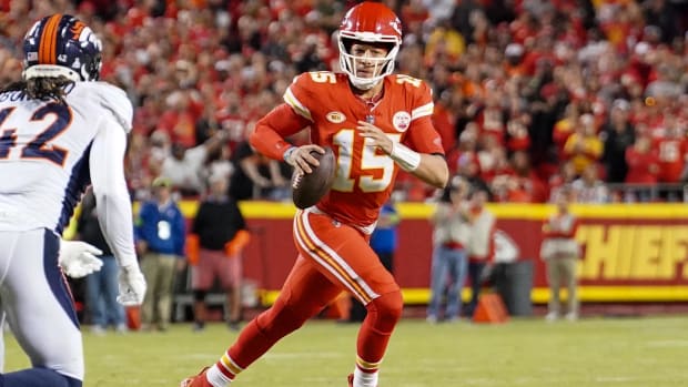 Kansas City Chiefs quarterback Patrick Mahomes (15) rolls out against the Denver Broncos 