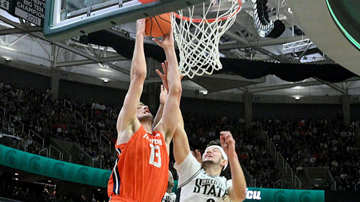 Jan 19, 2025; East Lansing, Michigan, USA;  Illinois Fighting Illini center Tomislav Ivisic (13) dunks the ball during the first half against the Michigan State Spartans at Jack Breslin Student Events Center. Mandatory Credit: Dale Young-Imagn Images