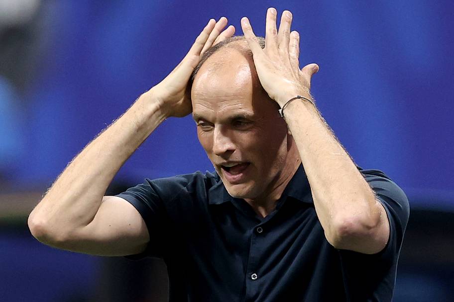 Thomas Tuchel rubbing his balding head.