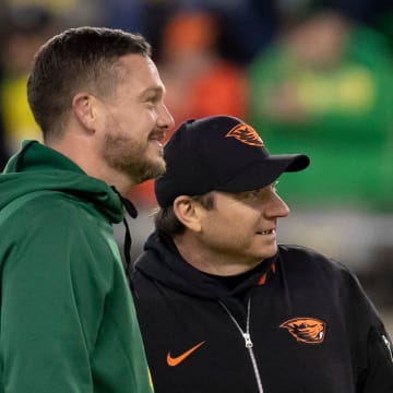 Oregon head coach Dan Lanning and Oregon State head coach Jonathan Smith watch warm ups as the No. 6 Oregon Ducks take on the No. 16 Oregon State Beavers Friday, Nov. 24, 2023, at Autzen Stadium in Eugene, Ore.