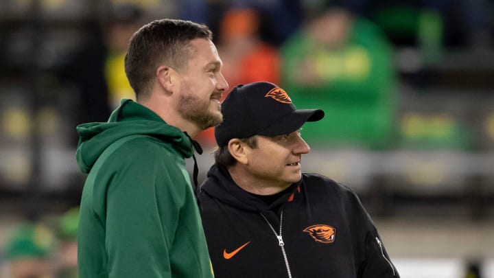 Oregon head coach Dan Lanning and Oregon State head coach Jonathan Smith watch warm ups as the No. 6 Oregon Ducks take on the No. 16 Oregon State Beavers Friday, Nov. 24, 2023, at Autzen Stadium in Eugene, Ore.