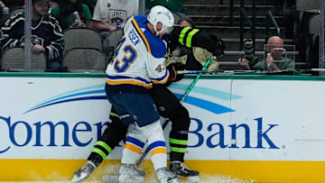 Apr 13, 2023; Dallas, Texas, USA;  Dallas Stars center Radek Faksa (12) is checked by St. Louis Blues defenseman Calle Rosen (43) during the second period at American Airlines Center. Mandatory Credit: Chris Jones-Imagn Images