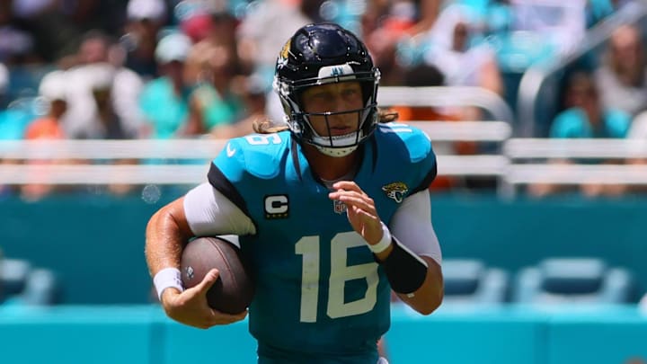 Sep 8, 2024; Miami Gardens, Florida, USA; Jacksonville Jaguars quarterback Trevor Lawrence (16) runs with the football against the Miami Dolphins during the first quarter at Hard Rock Stadium. Mandatory Credit: Sam Navarro-Imagn Images