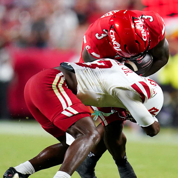 Nebraska defensive back Marques Buford Jr. tackles Cincinnati running back Tawee Walker in season opener.