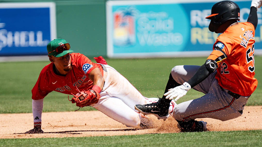 Kristian Campbell, of the Boston Red Sox tags out Luis Vasquez of the Baltimore Orioles at second base during a Spring Training game at JetBlue Park in Fort Myers on Saint Patrick's Day, 2025. 