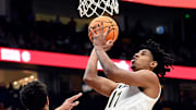 Vanderbilt guard A.J. Hoggard (11) shoots over Texas forward Kadin Shedrick (5) during a NCAA college basketball first round game at the men’s Southeastern Conference Tournament Wednesday, March 12, 2025, in Nashville, Tenn.