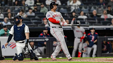 Boston Red Sox designated hitter Rafael Devers (11) reacts after hitting a solo home run 