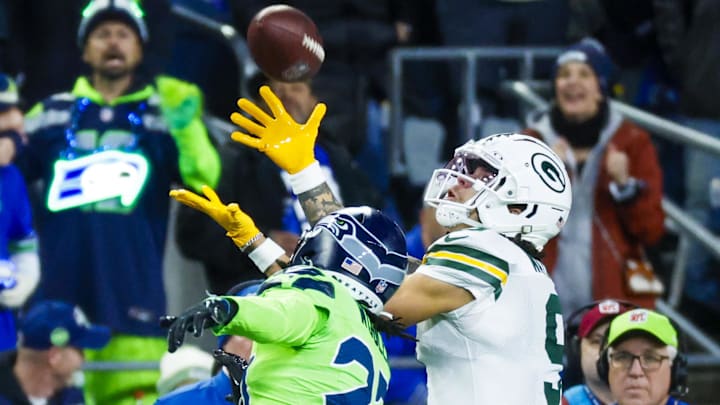 Green Bay Packers wide receiver Christian Watson (9) catches a pass against Seattle Seahawks cornerback Riq Woolen. Green Bay Packers wide receiver Christian Watson (9) catches a pass against Seattle Seahawks cornerback Riq Woolen.