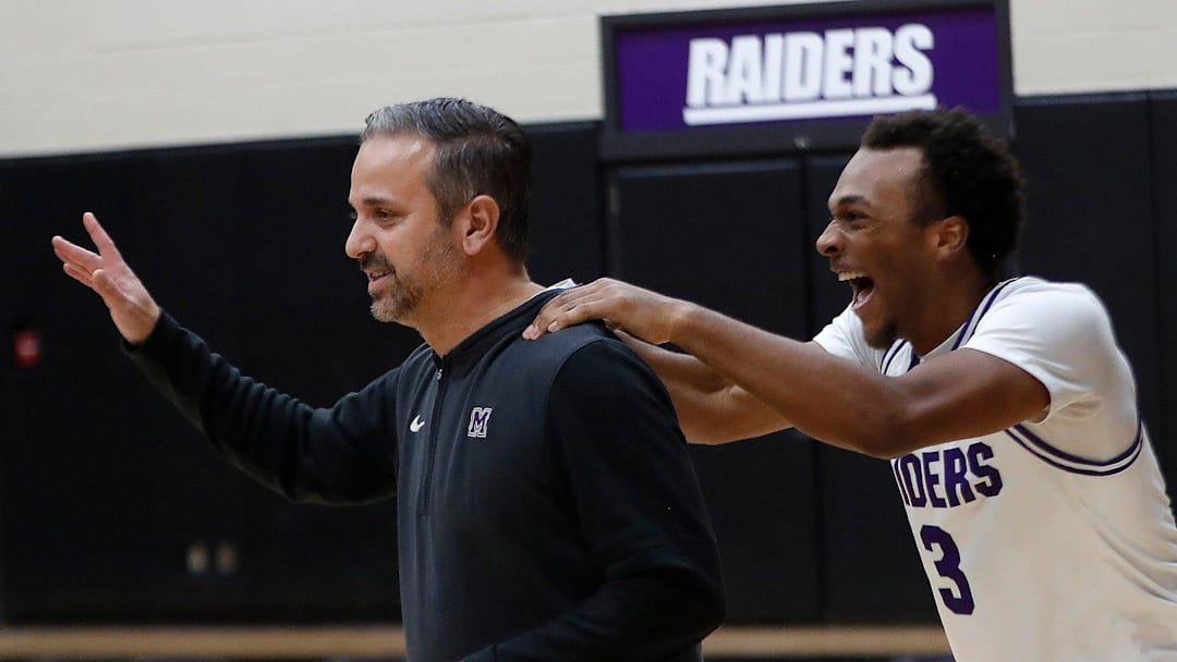 Following their win Wednesday, Mount Union's Marcus Steele, right, congratulates head coach Mike Fuline after the latter was recognized for becoming the program's all-time winningest coach last week, Jan. 8, 2025.