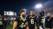 Wake Forest football players walk off the field after the game against North Carolina