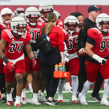 The Louisville defense takes to the field during practice on April 12, 2024