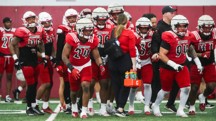 The Louisville defense takes to the field during practice on April 12, 2024