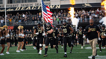 The Wake Forest Demon Deacons take to the field in the game against North Carolina