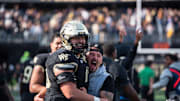 Wake Forest players and staff embrace after win over SMU