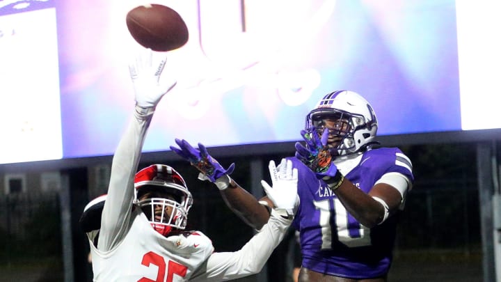 Calvary's Michael Smith attempts to make a touchdown catch as Thomasville's Don McCall attempts to break up the play during Friday night's 2nd round matchup.