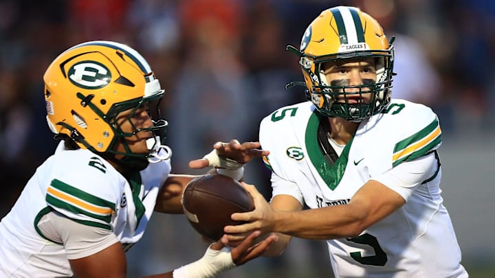 St. Edwards quarterback hands the ball off to running back during action Friday night, September 19, 2025 at Paul Brown Tiger Stadium. Ed Hall Jr. / Special To The Repository St. Edwards quarterback hands the ball off to running back during action Friday night, September 19, 2025 at Paul Brown Tiger Stadium. Ed Hall Jr. / Special To The Repository