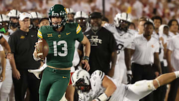 Oct 5, 2024; Ames, Iowa, USA; Baylor Bears quarterback Sawyer Robertson (13) runs for a first down against the Iowa State Cyclones at Jack Trice Stadium. The Cyclones beat the Bears 43 to 21.  Mandatory Credit: Reese Strickland-Imagn Images