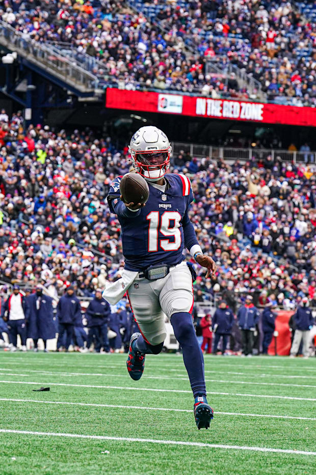 New England Patriots quarterback Joe Milton III runs the ball for a touchdown against the Buffalo Bills. 