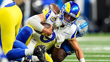 Los Angeles Rams quarterback Matthew Stafford (9) is sacked by Detroit Lions defensive end Levi Onwuzurike (91) during the first half at Ford Field in Detroit on Sunday, September 8, 2024.