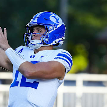 Sep 14, 2024; Laramie, Wyoming, USA; Brigham Young Cougars quarterback Jake Retzlaff (12) warms up before the game against the Wyoming Cowboys at Jonah Field at War Memorial Stadium.