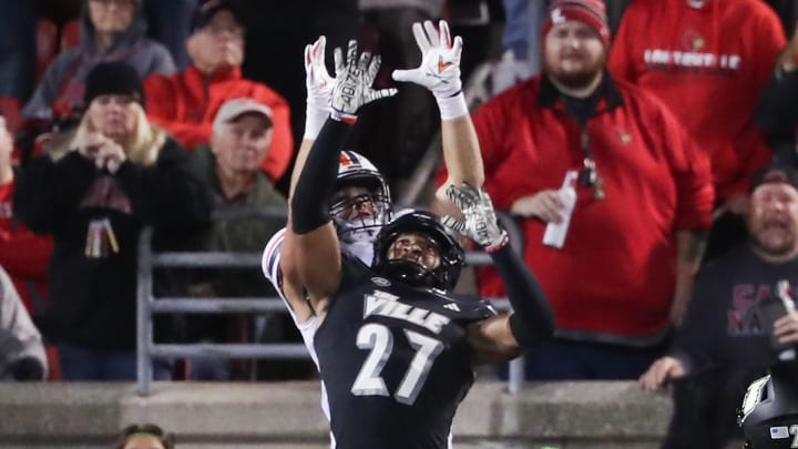 U of L's Devin Neal (27) broke up a touchdown pass attempt to Virginia's Grant Misch (85) during their game at the L&N Stadium in Louisville, Ky. on Nov. 9, 2023.