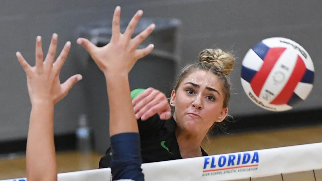 Izzy Starck of Viera drives the kill shot around the St. Thomas Aquinas block during the FHSAA state Class 6A volleyball tournament final Thursday, November 9 2023 at Polk State College. Izzy Starck of Viera drives the kill shot around the St. Thomas Aquinas block during the FHSAA state Class 6A volleyball tournament final Thursday, November 9 2023 at Polk State College.