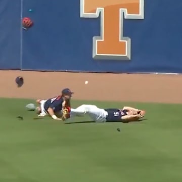 Ole Miss players collide in the outfield.
