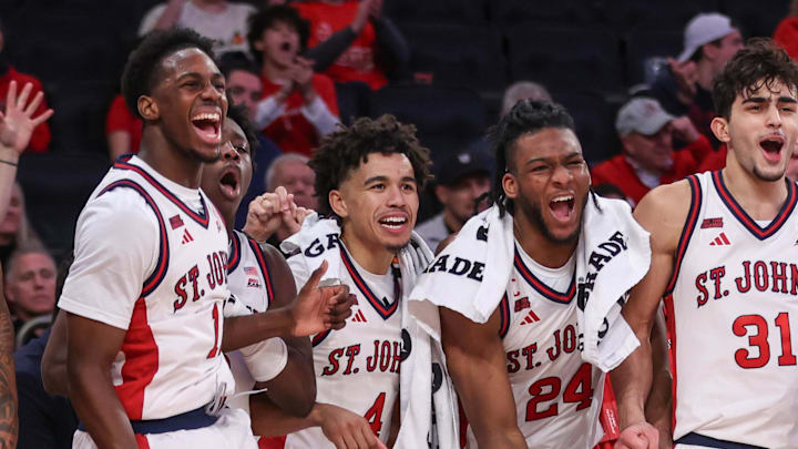 Dec 13, 2025; Queens, New York, USA;  The St. John's basketball bench celebrates with Ian Jackson in the second half against the Iona Gaels at Madison Square Garden. 