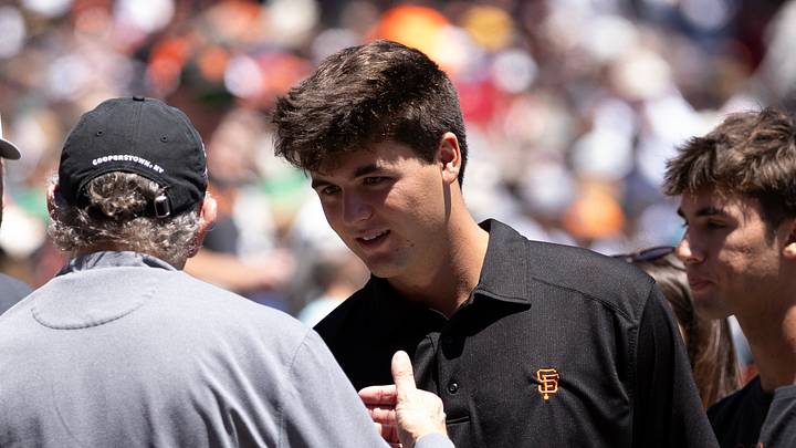 San Francisco, California, USA; San Francisco Giants top draft pick Jackson Flora (second from right) greets team president Larry Baer before a game against the Milwaukee Brewers at Oracle Park. Mandatory Credit: D. Ross Cameron-Imagn Images