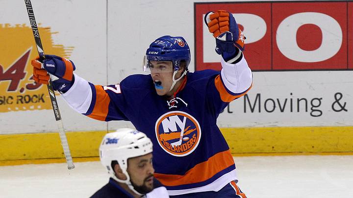 Apr 2, 2013; Uniondale, NY, USA; New York Islanders center Anders Lee (27) reacts after scoring his first career goal during the first period of his first career game during the first period of an NHL game against the Winnipeg Jets at Nassau Veterans Memorial Coliseum. Mandatory Credit: Brad Penner-Imagn Images