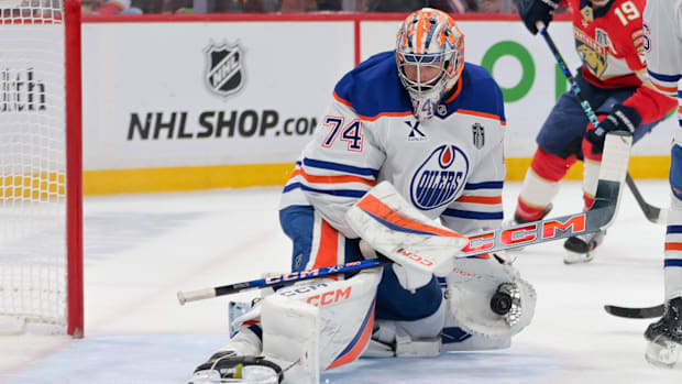 Hockey goalie in white uniform