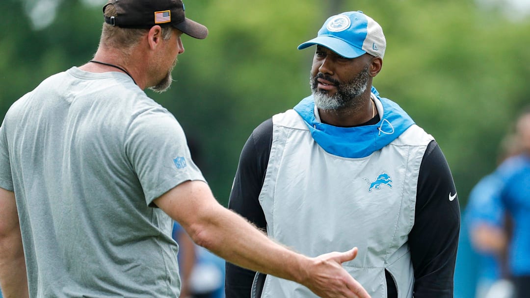 Detroit Lions head coach Dan Campbell, left, talks to general manager Brad Holmes during minicamp 