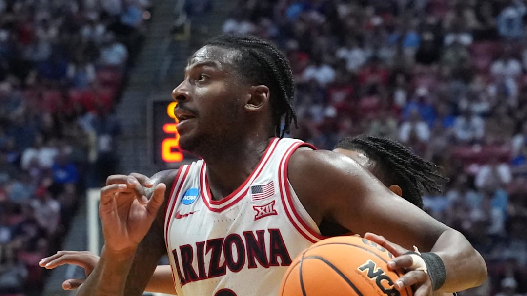 Mar 22, 2026; San Diego, CA, USA; Arizona Wildcats guard Jaden Bradley (0) controls the ball against Utah State Aggies guard Elijah Perryman (1) in the first half during a second round game of the men's 2026 NCAA Tournament at Viejas Arena. Mandatory Credit: Kirby Lee-Imagn Images
