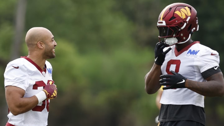 Jul 25, 2024; Ashburn, VA, USA; Washington Commanders running back Austin Ekeler (30) jokes with Washington Commanders running back Brian Robinson Jr. (8) on day two of training camp at OrthoVirginia Training Center at Commanders Park. Mandatory Credit: Geoff Burke-USA TODAY Sports