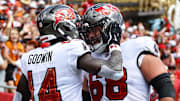 Sep 22, 2024; Tampa, Florida, USA; Tampa Bay Buccaneers wide receiver Chris Godwin (14) celebrates with guard Ben Bredeson (68) after he scored a touchdown against the Denver Broncos during the first half at Raymond James Stadium. Mandatory Credit: Kim Klement Neitzel-Imagn Images