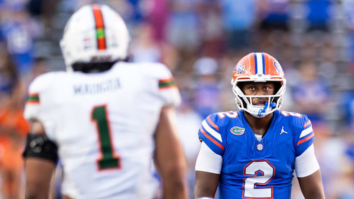 Aug 31, 2024; Gainesville, Florida, USA; Florida Gators quarterback DJ Lagway (2) stares at Miami Hurricanes linebacker Francisco Mauigoa (1) during the second half at Ben Hill Griffin Stadium. Mandatory Credit: Matt Pendleton-Imagn Images