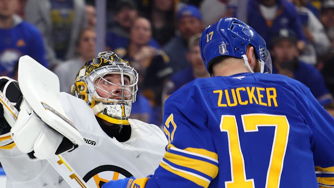 Apr 28, 2026; Buffalo, New York, USA; Buffalo Sabres left wing Jason Zucker (17) looks for the puck as Boston Bruins goaltender Jeremy Swayman (1) looks to knock it out of the air during the second period in game five of the first round of the 2026 Stanley Cup Playoffs at KeyBank Center. Mandatory Credit: Timothy T. Ludwig-Imagn Images