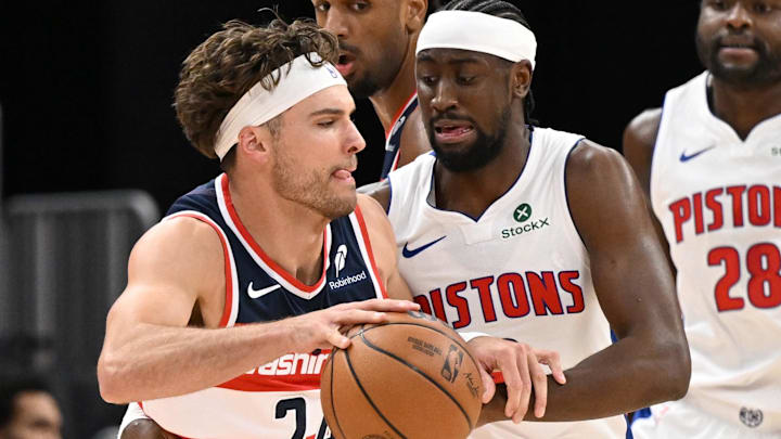 Oct 16, 2025; Detroit, Michigan, USA; Washington Wizards forward Corey Kispert (24) tries to drive past Detroit Pistons guard Caris LeVert (8) in the first quarter at Little Caesars Arena.