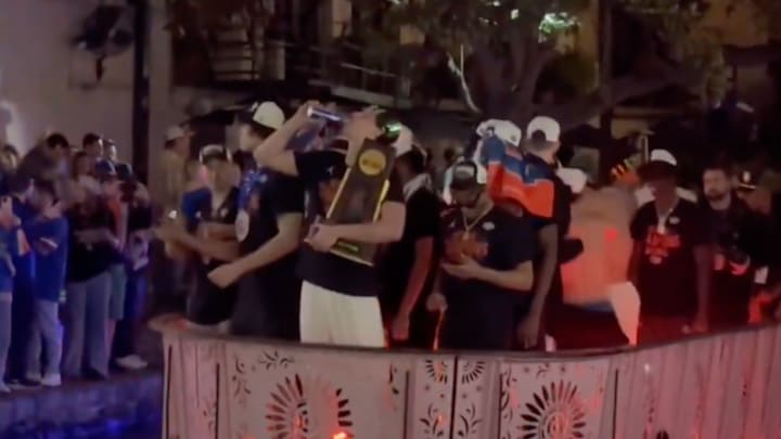 Micah Handlogten drinks a beer while holding the trophy. Micah Handlogten drinks a beer while holding the trophy.