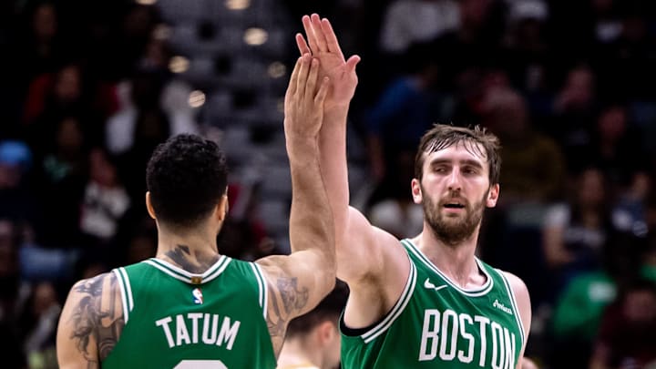 Jan 31, 2025; New Orleans, Louisiana, USA;  Boston Celtics center Luke Kornet (40) slaps hands with forward Jayson Tatum (0) after dunking the ball against the New Orleans Pelicans during the second half at Smoothie King Center. Mandatory Credit: Stephen Lew-Imagn Images