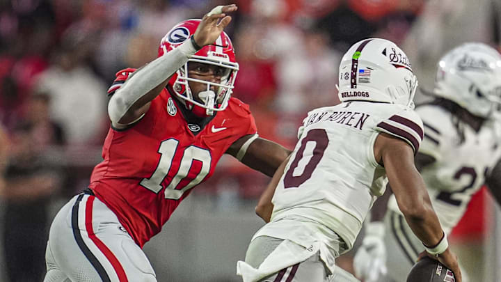 Oct 12, 2024; Athens, Georgia, USA; Georgia Bulldogs linebacker Damon Wilson II (10) tries to tackle Mississippi State Bulldogs quarterback Michael Van Buren Jr. (0) at Sanford Stadium. Mandatory Credit: Dale Zanine-Imagn Images Oct 12, 2024; Athens, Georgia, USA; Georgia Bulldogs linebacker Damon Wilson II (10) tries to tackle Mississippi State Bulldogs quarterback Michael Van Buren Jr. (0) at Sanford Stadium. Mandatory Credit: Dale Zanine-Imagn Images