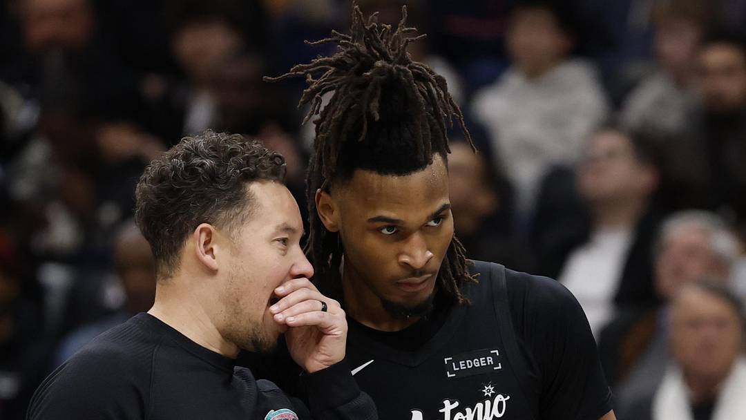Dec 21, 2025; Washington, District of Columbia, USA; San Antonio Spurs head coach Mitch Johnson (L)) talks with Spurs guard Stephon Castle (5) during a timeout against the Washington Wizards in the second half at Capital One Arena. Mandatory Credit: Geoff Burke-Imagn Images