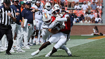 Sep 13, 2025; Auburn, Alabama, USA;  South Alabama Jaguars running back Keenan Phillips (21) is tackled by Auburn Tigers safety Eric Winters (25) during the fourth quarter at Jordan-Hare Stadium. Mandatory Credit: John Reed-Imagn Images