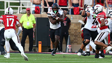 Oct 25, 2025; Lubbock, Texas, USA;  Oklahoma State Cowboys running back Trent Howland (24) rushes against the Texas Tech Red Raiders in the second half at Jones AT&T Stadium. Mandatory Credit: Michael C. Johnson-Imagn Images