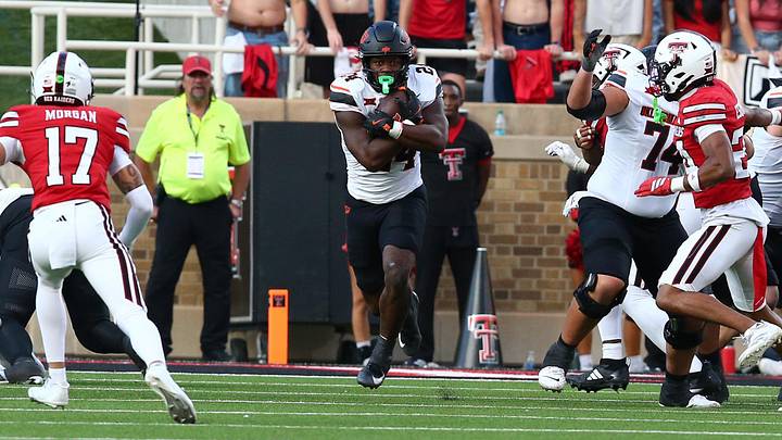 Oct 25, 2025; Lubbock, Texas, USA;  Oklahoma State Cowboys running back Trent Howland (24) rushes against the Texas Tech Red Raiders in the second half at Jones AT&T Stadium. Mandatory Credit: Michael C. Johnson-Imagn Images