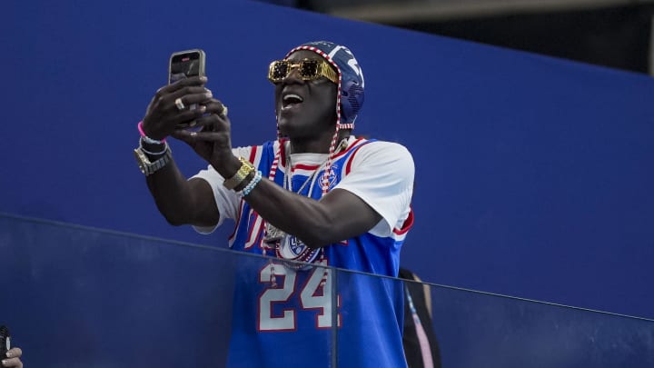 Jul 31, 2024; Paris, France; Flava Flav watches team USA during the fourth quarter during the Paris 2024 Olympic Summer Games at Aquatics Centre. 