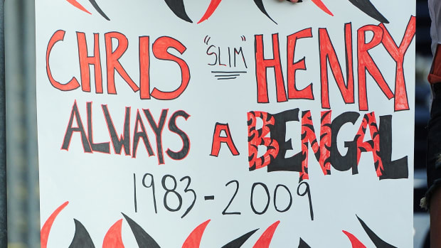 Cincinnati Bengals fan Wes Schilderink, from Cincinnati, holds a sign in honor of wide receiver Chris Henry