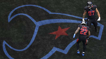 Houston Texans tight end Cade Stover (87) celebrates running back Cam Akers (22)